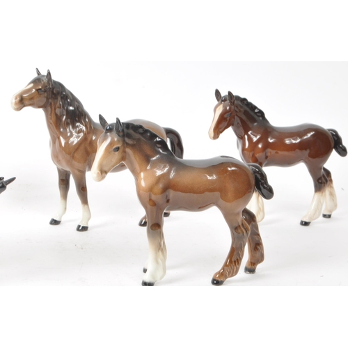 197 - Beswick - A collection of seven 20th century porcelain horse figurines, to include two shire foals, ... 