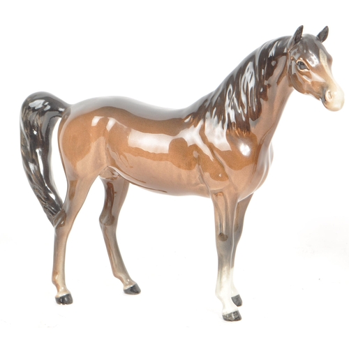 198 - Beswick - Three 20th century porcelain horse figurines, including a Prancing Arab horse, an Arab Axa... 