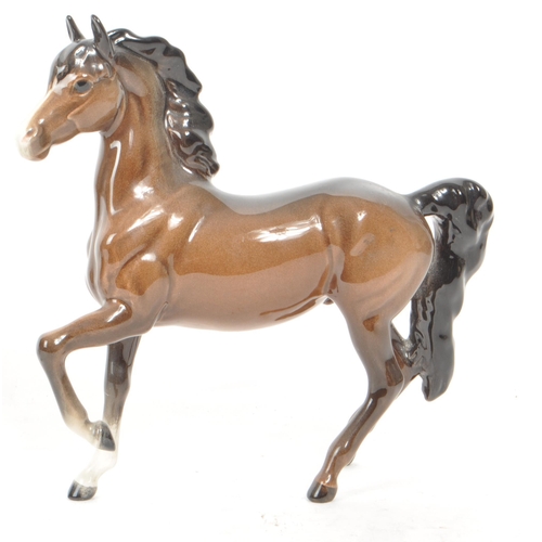 198 - Beswick - Three 20th century porcelain horse figurines, including a Prancing Arab horse, an Arab Axa... 