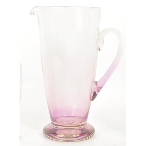 199 - A vintage 20th century glass lemonade set. Comprising of a glass pitcher jug with a set of six high ... 