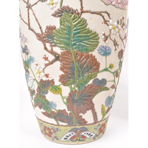 200 - Two 20th century ceramic Chinese baluster vases, with enameled relief floral patterning to the bodie... 