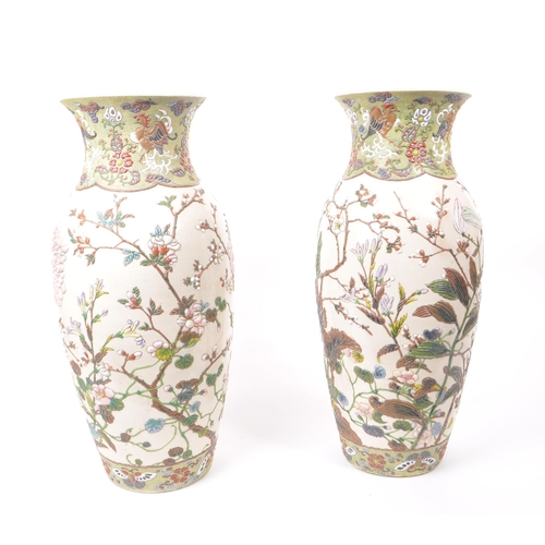 200 - Two 20th century ceramic Chinese baluster vases, with enameled relief floral patterning to the bodie... 