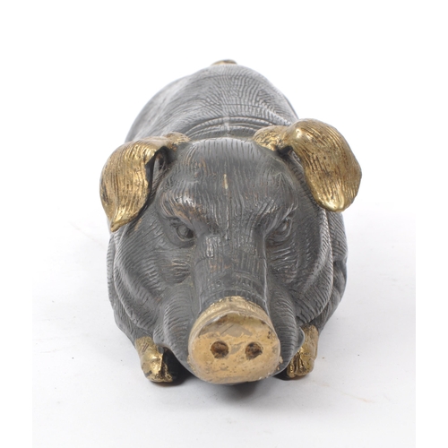 201 - A vintage 20th-century bronze figure of a pig lying down, with gilt detailing to the feet, nose, tai... 