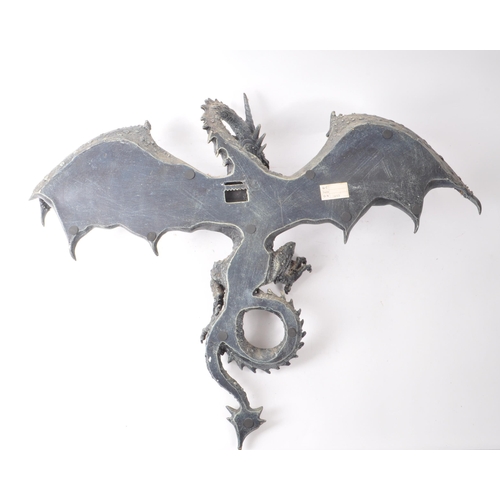 206 - Two contemporary resin dragon wall-hanging figures, including a dark blue painted dragon with its wi... 