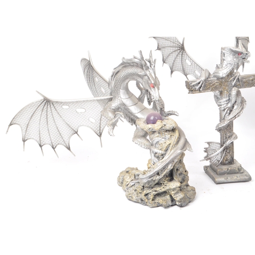 207 - A collection of four contemporary plastic / resin dragon figures. Comprising of 'Dragon on Cross Wit... 