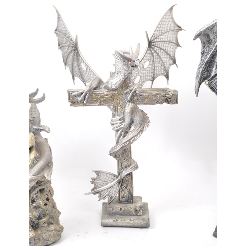 207 - A collection of four contemporary plastic / resin dragon figures. Comprising of 'Dragon on Cross Wit... 