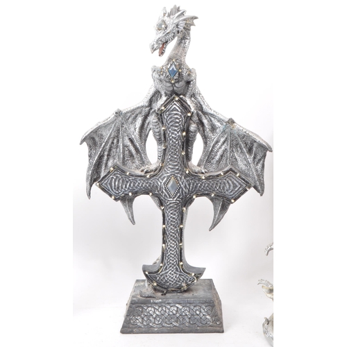 207 - A collection of four contemporary plastic / resin dragon figures. Comprising of 'Dragon on Cross Wit... 