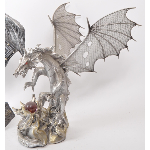 207 - A collection of four contemporary plastic / resin dragon figures. Comprising of 'Dragon on Cross Wit... 