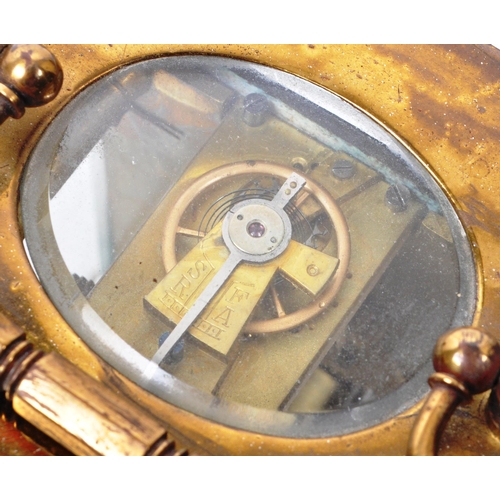 212 - An early 20th-century carriage clock, with a brass case and handle, glass beveled sides, and a see-t... 