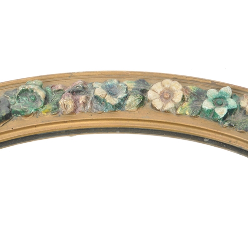 219 - An early 20th century circa 1930s barbola mirror. The mirror of oval form, with relief floral decora... 