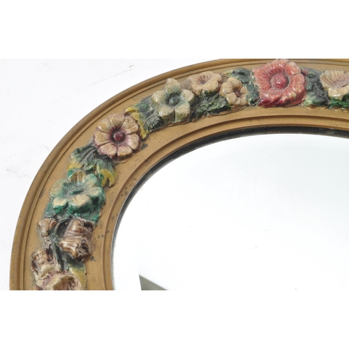 219 - An early 20th century circa 1930s barbola mirror. The mirror of oval form, with relief floral decora... 