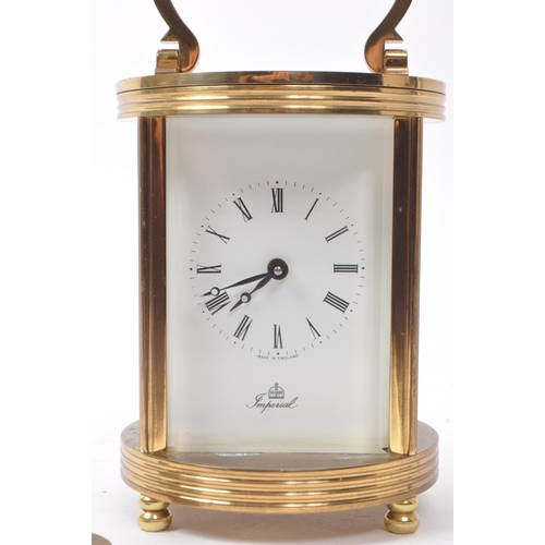 221 - Imperial - A 20th century brass cased carriage clock. The clock raised on rounded feet. Having round... 