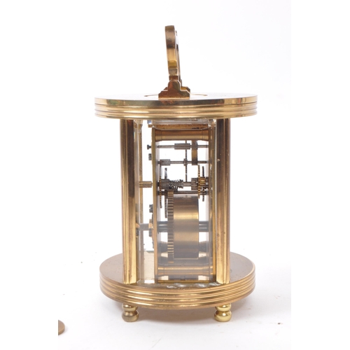 221 - Imperial - A 20th century brass cased carriage clock. The clock raised on rounded feet. Having round... 