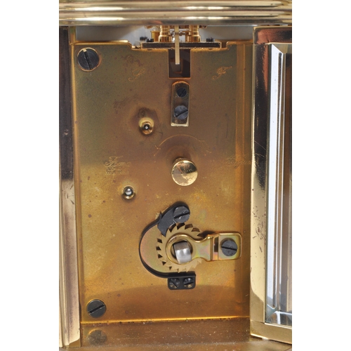 221 - Imperial - A 20th century brass cased carriage clock. The clock raised on rounded feet. Having round... 