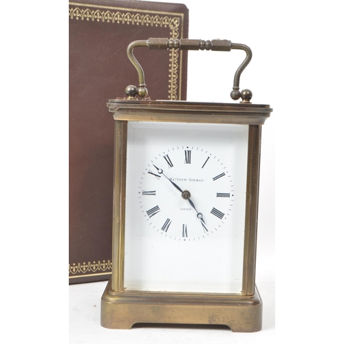 225 - Matthew Norman - A 20th-century brass carriage clock, made in Switzerland. With beveled glass paneli... 