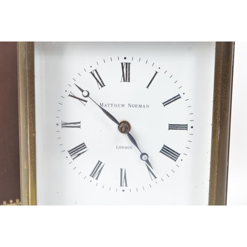 225 - Matthew Norman - A 20th-century brass carriage clock, made in Switzerland. With beveled glass paneli... 