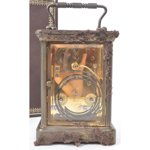 225 - Matthew Norman - A 20th-century brass carriage clock, made in Switzerland. With beveled glass paneli... 