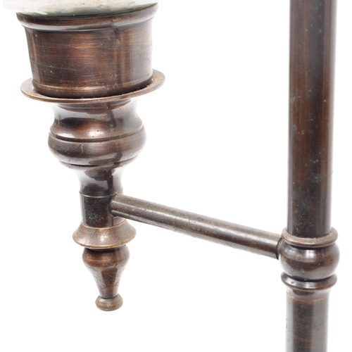 230 - An early 20th century brass and glass pillar candle holder. Brass central support column with finial... 