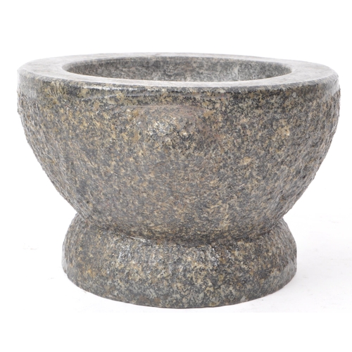 238 - A 20th-century large granite molcajete / pestle and mortar, with two stump handles and a flared base... 