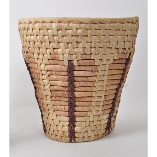 266 - Two vintage 20th century woven waste paper baskets / planters. Each of rounded form with woven patte... 