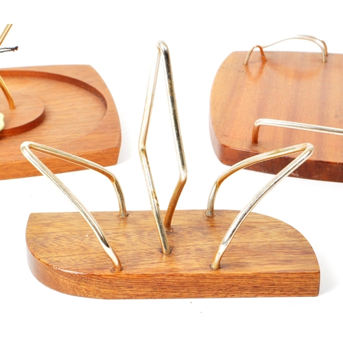 267 - Wyncraft - A collection of three teak mid-century tableware pieces, comprised of a shot glass holder... 