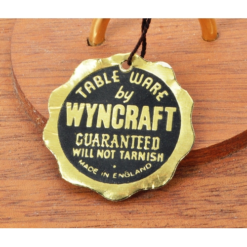 267 - Wyncraft - A collection of three teak mid-century tableware pieces, comprised of a shot glass holder... 