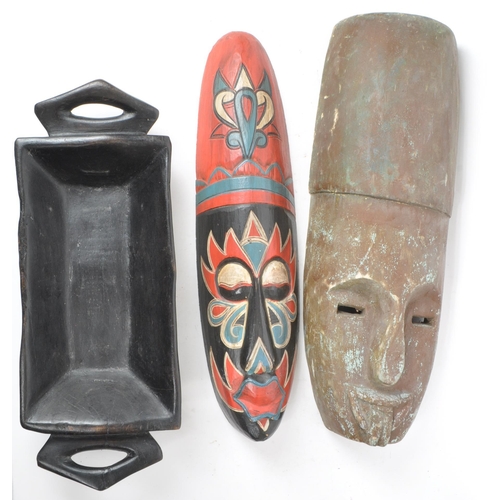 273 - A collection of three 20th century tribal African carved wooden pieces, consisting of two carved mas... 