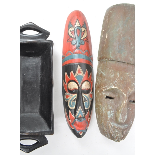 273 - A collection of three 20th century tribal African carved wooden pieces, consisting of two carved mas... 