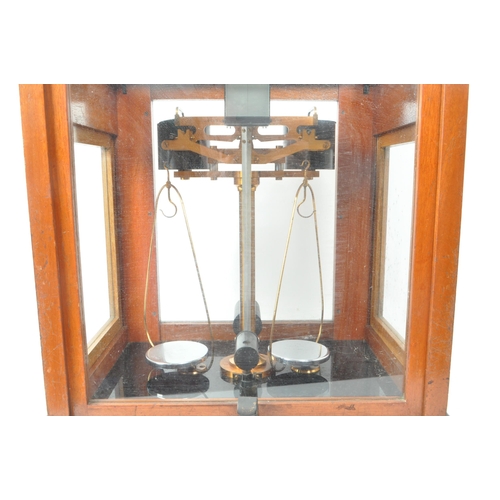 277 - L. Oertling Ltd - An early 20th century London balance scales model. 52F.M and weights, stored in a ... 