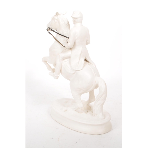 28 - A vintage 20th century white porcelain man riding a horse figure, featuring attached leather straps ... 