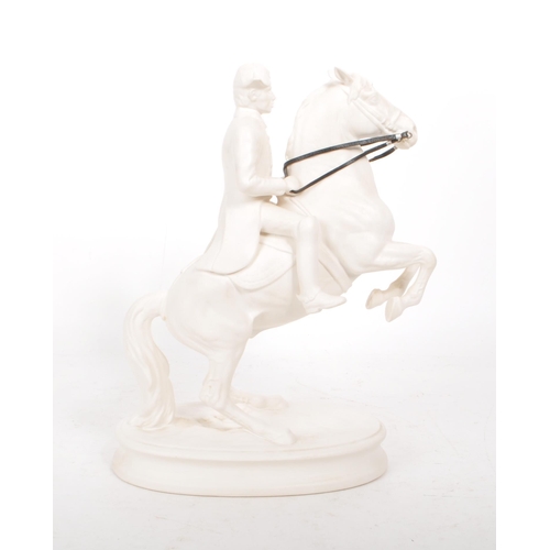 28 - A vintage 20th century white porcelain man riding a horse figure, featuring attached leather straps ... 