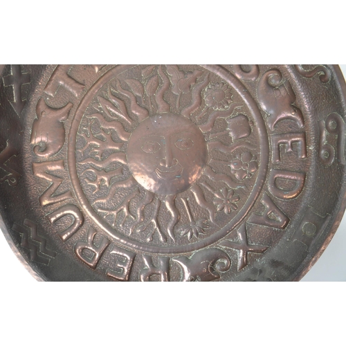 280 - An early 20th century large repousse Zodiac wall charger, with the Latin lettering 'Tempus Edax Reru... 