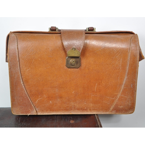 282 - Three 20th century leather bags, including a Gladstone leather satchel, a Fisher trunk / briefcase, ... 