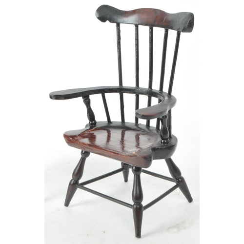 284 - A pair of 20th century paper mache combe back windsor chairs. The chairs having shaped top rail with... 