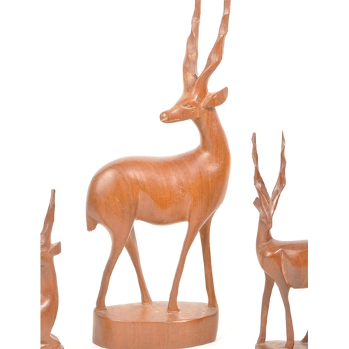 288 - Five 1960s / 1970s teak carved antelope / deer ornament sculptures, comprised of two adult antelope ... 