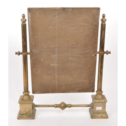 301 - A vintage early 20th century brass swing mirror, raised on two plinth-style feet. Measuring approx. ... 