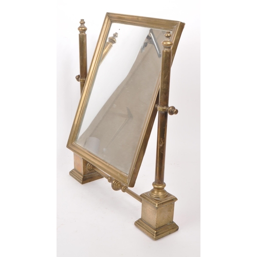 301 - A vintage early 20th century brass swing mirror, raised on two plinth-style feet. Measuring approx. ... 