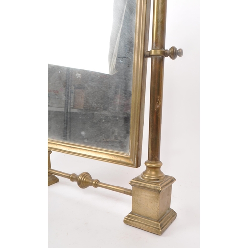 301 - A vintage early 20th century brass swing mirror, raised on two plinth-style feet. Measuring approx. ... 