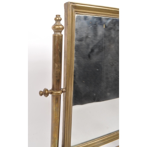 301 - A vintage early 20th century brass swing mirror, raised on two plinth-style feet. Measuring approx. ... 