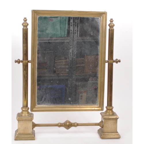 301 - A vintage early 20th century brass swing mirror, raised on two plinth-style feet. Measuring approx. ... 