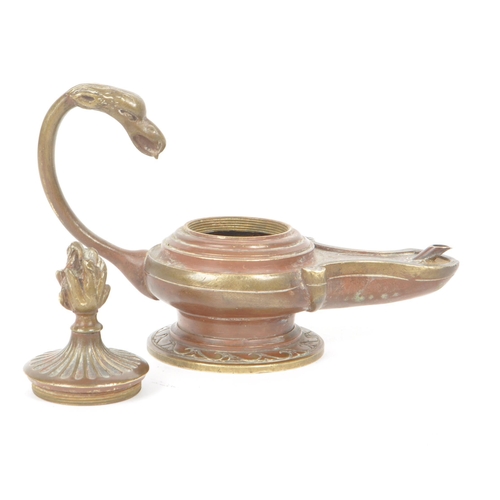 304 - A 19th century Victorian bronze oil lamp, with a dragon shaped looping handle and carved lid that li... 