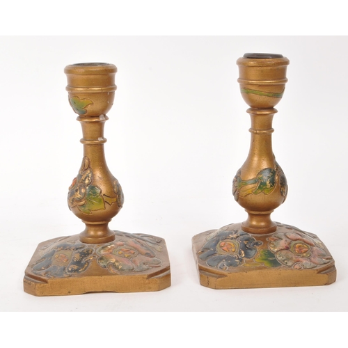 307 - Two 20th century believed to be Japanese wooden candle stick holders, featuring carved and hand pain... 