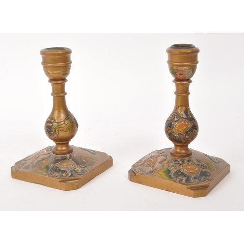 307 - Two 20th century believed to be Japanese wooden candle stick holders, featuring carved and hand pain... 