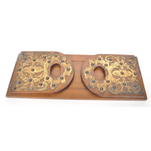 309 - A mid century mahogany folding / metamorphic book stand, with brass work with fleur de lys patterns ... 