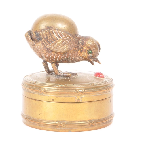 310 - Early 20th century gilt painted brass trinket box, featuring a chick and a red painted lady painted ... 