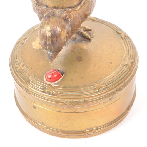 310 - Early 20th century gilt painted brass trinket box, featuring a chick and a red painted lady painted ... 