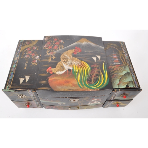 313 - 20th century Chinese lacquered jewelry and music box, with five drawers to the front and a lid that ... 