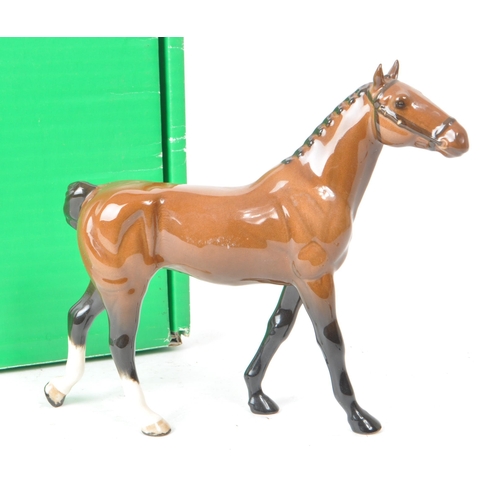 32 - Beswick - A 20th-century china brown gloss 'Hackney Pony' no. H261 figurine. Featuring a brown horse... 