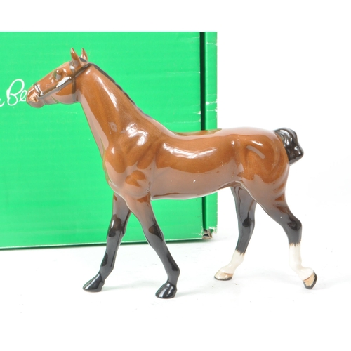 32 - Beswick - A 20th-century china brown gloss 'Hackney Pony' no. H261 figurine. Featuring a brown horse... 