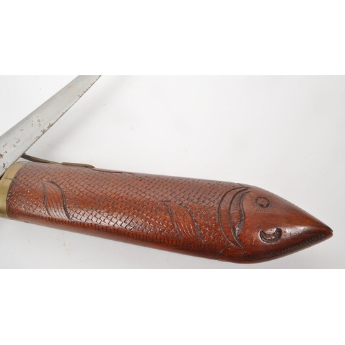 333 - A vintage 20th century Indian fish carving knife set housed in a sheath carved as a fish with brass ... 